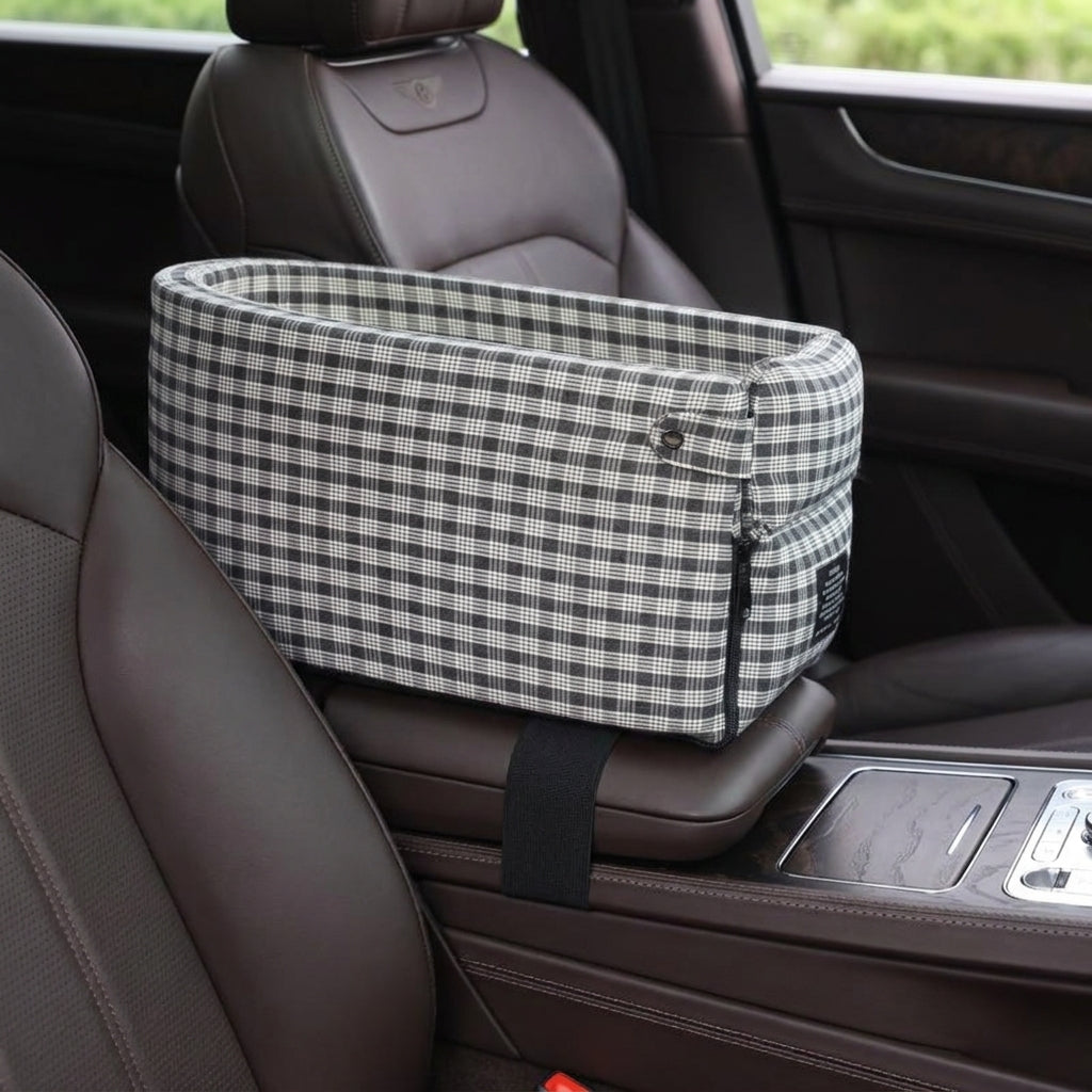 Tomo Console Seat in Charcoal Plaid mounted on a car centre console, dark leather interior