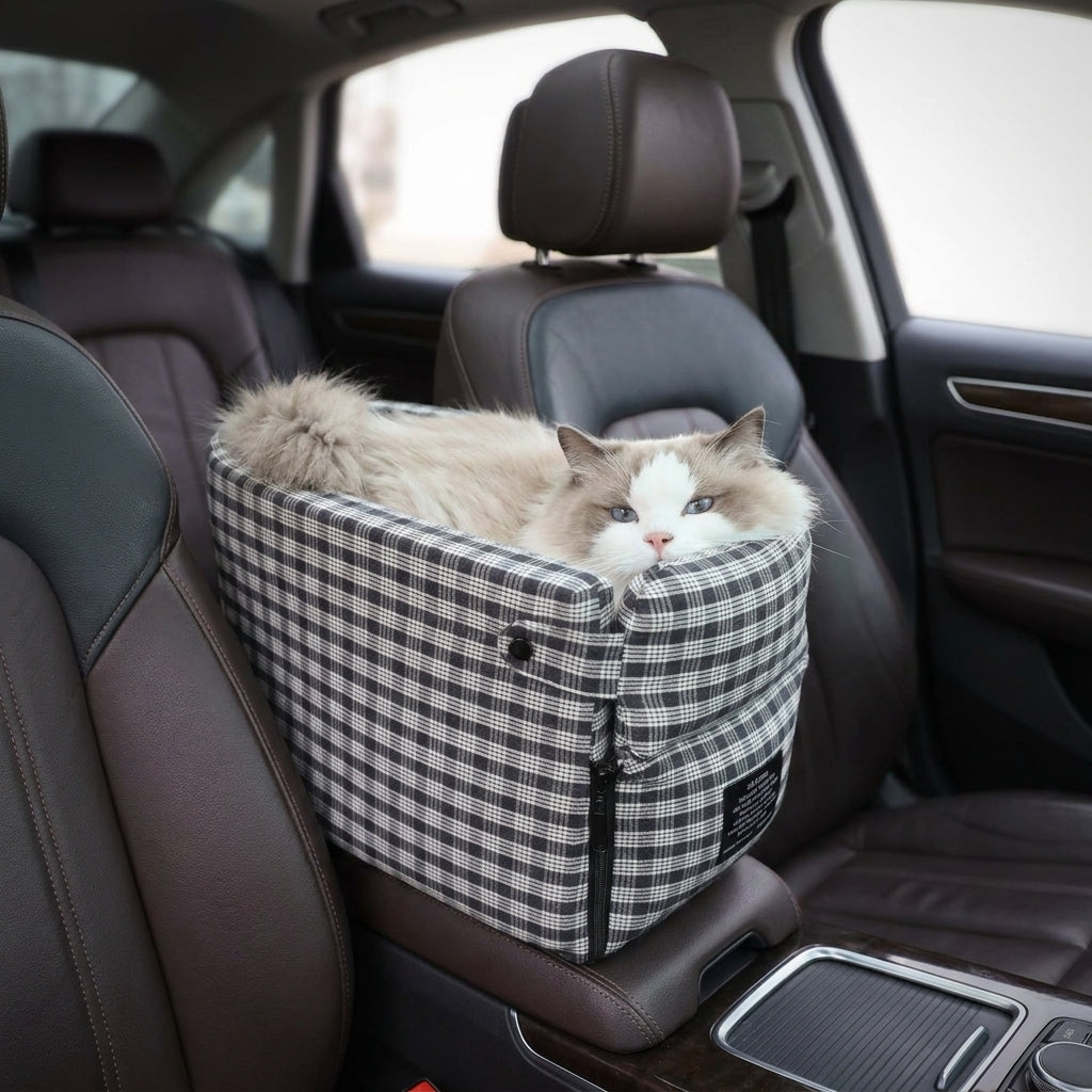 Long-haired cat resting inside the Tomo Console Seat in Charcoal Plaid in a car cabin
