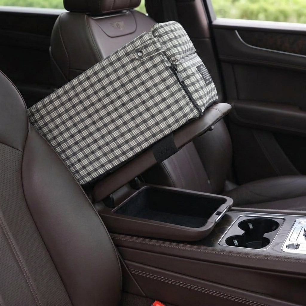 Centre console lid tilted open with the Tomo Console Seat still strapped on top, storage compartment accessible